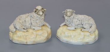 A pair of Samuel Alcock porcelain figures of recumbent sheep, c.1830-45, impressed no. 6, l. 9.