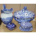 A blue and white jug, lidded tureen, a small tureen, cover and stand and a two handled lidded bowl