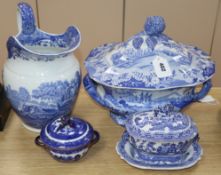 A blue and white jug, lidded tureen, a small tureen, cover and stand and a two handled lidded bowl