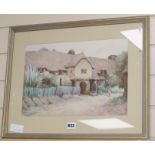 Herbert E. Butler, watercolour, Figure feeding doves beside a thatched house, signed 26 x 37cm