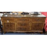 A walnut sideboard fitted cupboards and drawers W.177cm