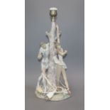 A Lladro group of dancers by tree