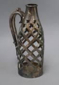 An early 20th century pierced silver plated bottle holder, engraved with crest, 27cm.