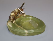 A cold plated bronze model of a dog and a green onyx ashtray