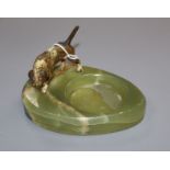 A cold plated bronze model of a dog and a green onyx ashtray