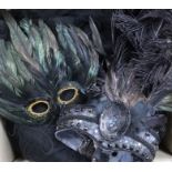 A collection of feather masks, a cape / collar etc.