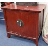 A Chinese red lacquered two door cabinet W.103cm