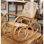 A caned bentwood rocking chair