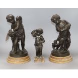 A pair of bronze figures of cherubs and another smaller tallest 30cm
