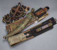 Two Middle Eastern sashes, one with dagger and a cross necklace