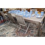 A wooden table with five dining chairs and one wooden steamer chair L.270cm