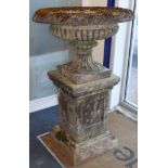 A reconstituted stone urn on pedestal H.130cm