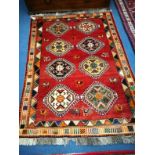 A Qashqai brick red ground geometric rug 175 x125 cm