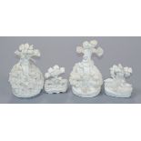 Four Staffordshire miniature biscuit groups of a shepherd and sheep, two deer and two sheep under