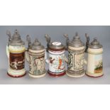 A collection of five pewter mounted beer steins