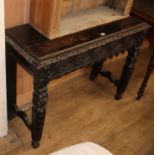 A carved oak side table W.104cm