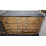 A Victorian zinc top pine twelve drawer chest W.142cm