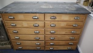 A Victorian zinc top pine twelve drawer chest W.142cm