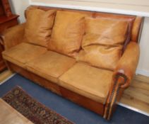 A tan leather three seater sofa bed W.185cm