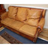 A tan leather three seater sofa bed W.185cm