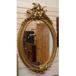 A Victorian style oval gilt frame wall mirror W.87cm