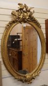 A Victorian style oval gilt frame wall mirror W.87cm