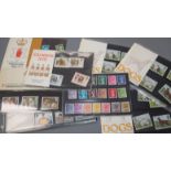 A group of Royal Mail First Day Covers, an album of cigarette cards and UK mint unused stamps