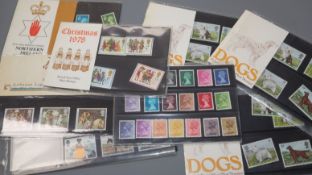 A group of Royal Mail First Day Covers, an album of cigarette cards and UK mint unused stamps