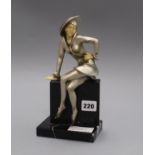 An Art Deco white metal and faux ivory figure