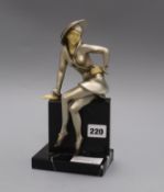 An Art Deco white metal and faux ivory figure