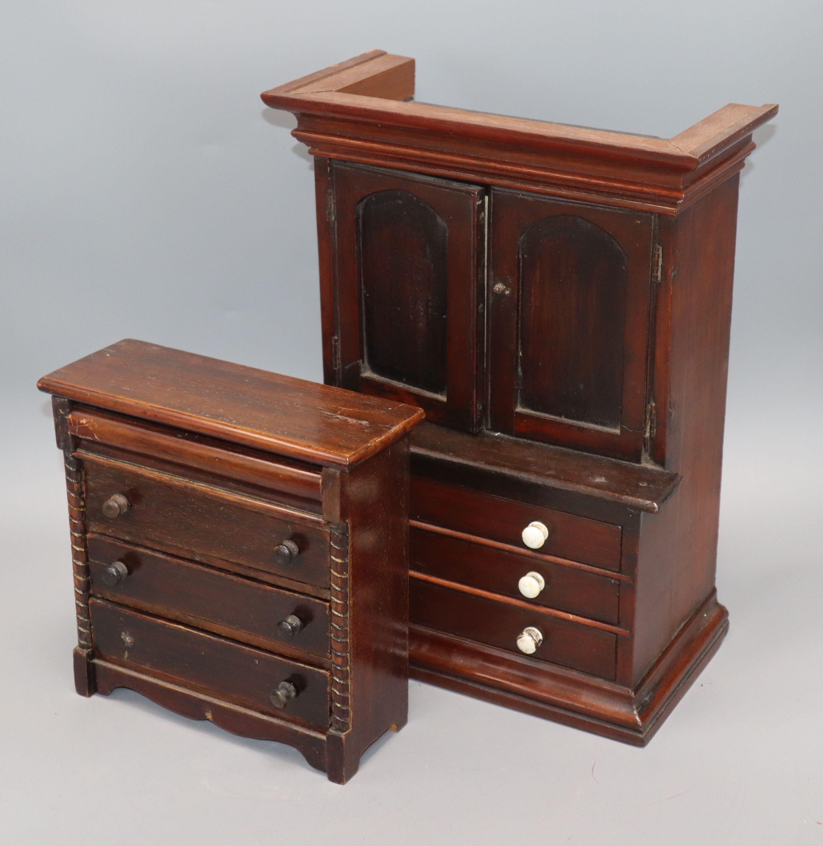 A Victorian mahogany miniature bookcase cabinet and similar chest of drawers