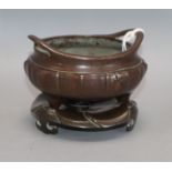 A Chinese bronze tripod censer and stand