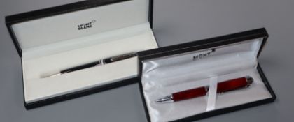 Two cased Montblanc ball point pens, one a Meisterstuck the other with wood body, both cased