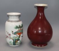 A Chinese famille rose peacock vase and a 19th century Chinese copper red glazed vase, 18th / 19th