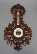 A late 19th century German carved walnut barometer and thermometer, by Rudolph Strange, Bunde and