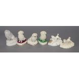 Six Staffordshire porcelain figures of poodles, c. 1830-50, one chasing a rat, h. 4.5-8.