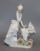 A Lladro of lady pushing a pram height 33.5cm