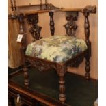 A carved walnut corner chair