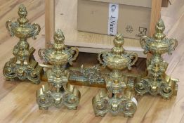 A pair of French brass andirons and fire curb
