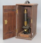 A microscope in a stained beech case