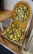 A pair of giltwood side chairs, the seats and backs with Versace yellow flower head print