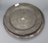 Three pewter chargers and a large early 19th century Continental pewter charger