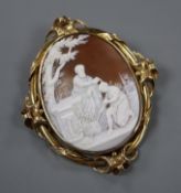 A late Victorian scrolling yellow metal mounted oval cameo brooch, carved with St John the