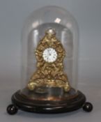 A 19th century brass timepiece under a glass dome clock 10cm high