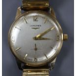 A gentleman's 9ct gold Longines manual wind wrist watch, on associated flexible strap.