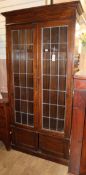 A 1920's oak leaded light bookcase W.96cm