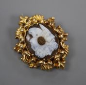 A Victorian yellow metal mounted chalcedony cameo brooch, the carving incorporating three
