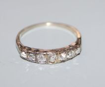 A white metal and graduated seven stone diamond half hoop ring, (tests as 14ct), size K.