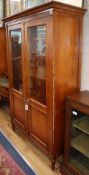 A pair of French federal-style cherrywood glazed bookcases W.122cm