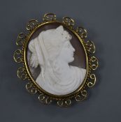 A 9ct mounted oval cameo brooch, carved with the bust of a lady to sinister, with scrolling